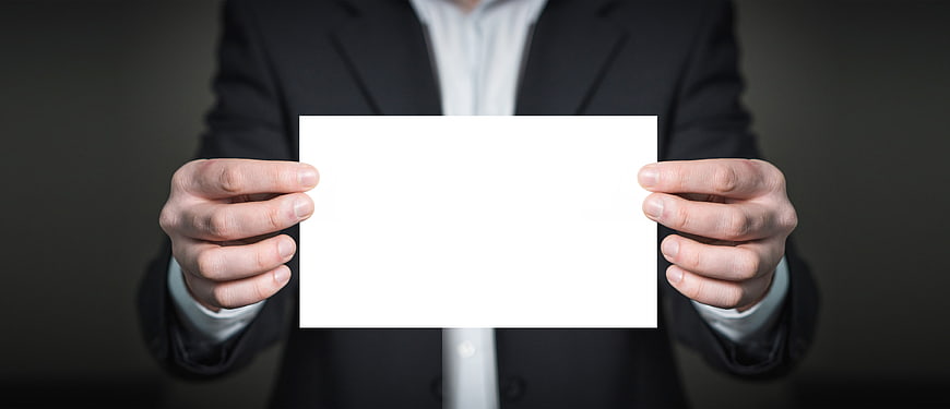 Businessman holding blank white card for text overlay