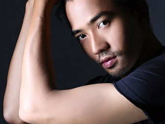 Portrait of Handsome Man with Arms Raised