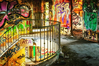 Colorful Graffiti Covered Staircase In Abandoned Building Interior