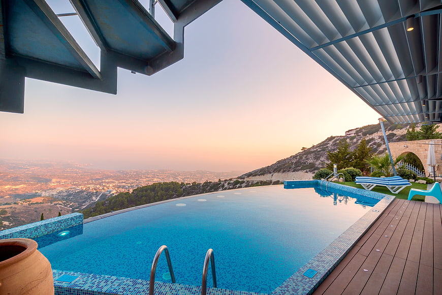 Infinity pool overlooking city at sunset