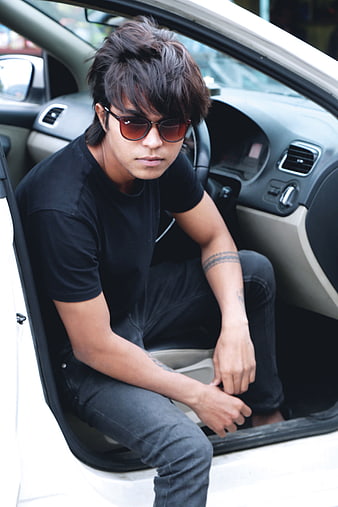 Handsome Young Man in Sunglasses Sitting in Car