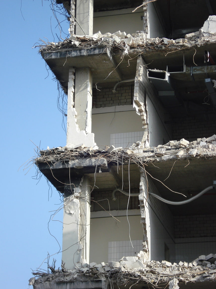 Demolished Concrete Building with Exposed Rebar and Rubble