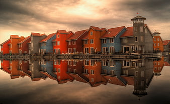 Colorful waterfront houses with perfect reflection in calm water