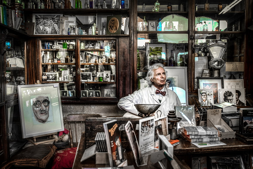 Old-fashioned chemist shop interior with man in white coat