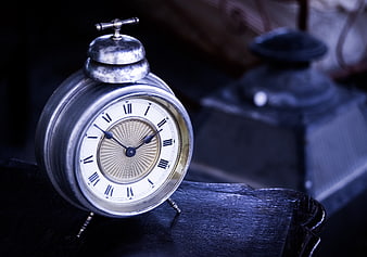 Vintage Silver Alarm Clock on Dark Wood