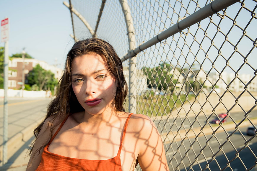 Woman with Chain Link Fence Shadows Portrait