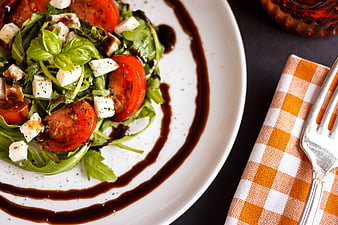 Fresh Caprese Salad With Basil And Balsamic Glaze On White Plate