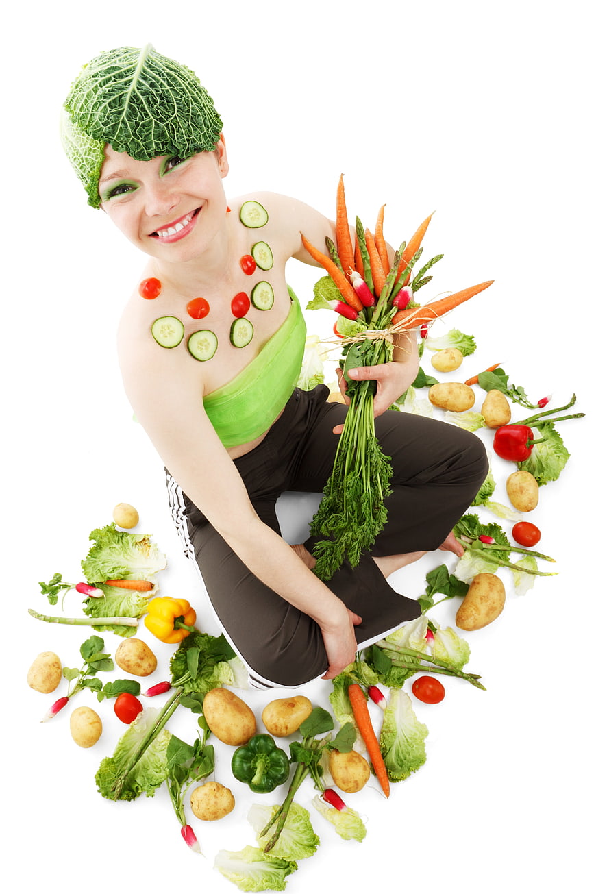 Woman with vegetable makeup holding fresh produce bouquet