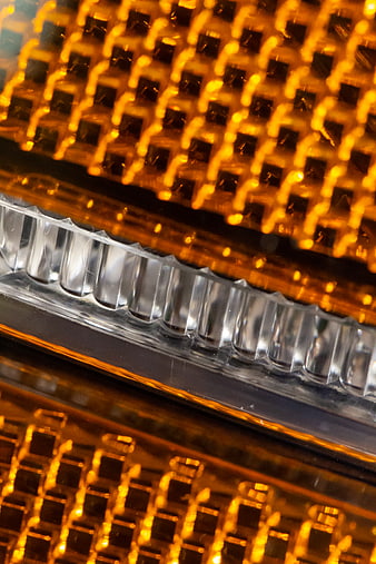 Close-up of glowing amber car turn signal light texture