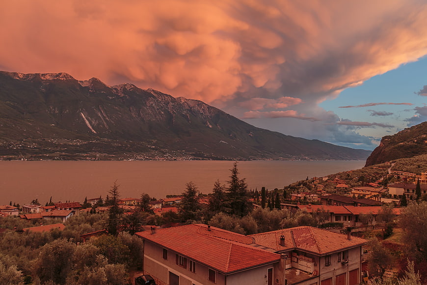 Dramatic sunset over Italian lake and mountains