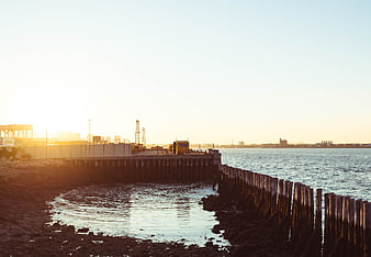 Sunset at Boston Harbor Construction Site with Wooden Breakwater