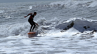 Surfer riding a wave in the ocean