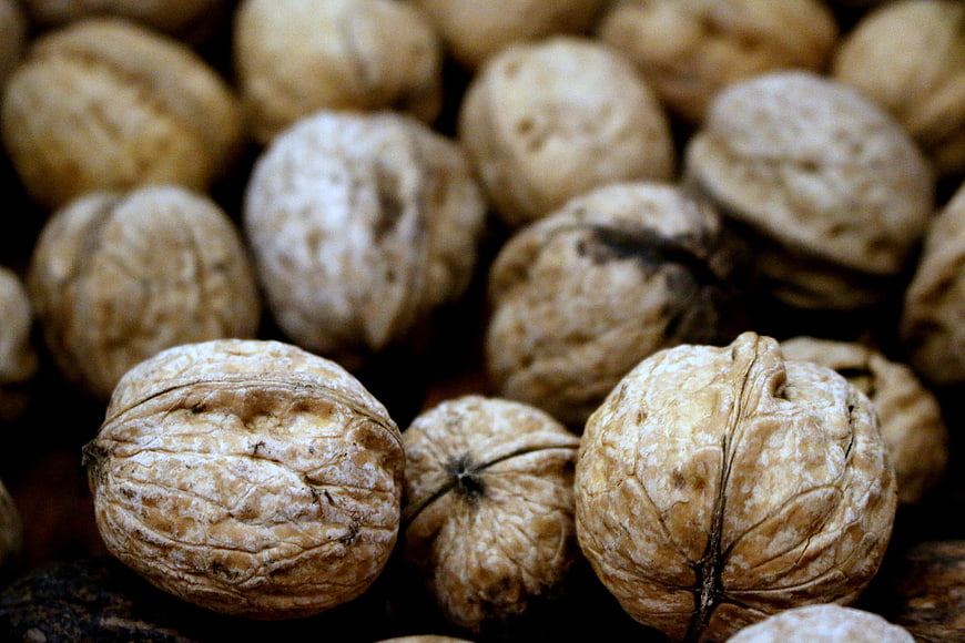 Close-up of whole walnuts with textured shells