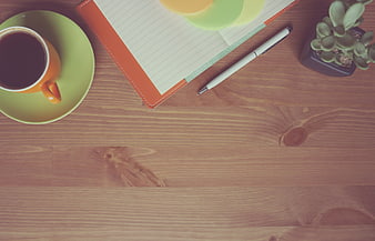 Top View of Coffee, Notebook, and Pen on Wooden Desk