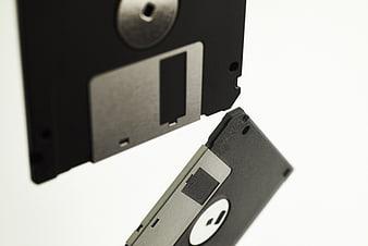 Floating 3.5 and 5.25 inch floppy disks on white background
