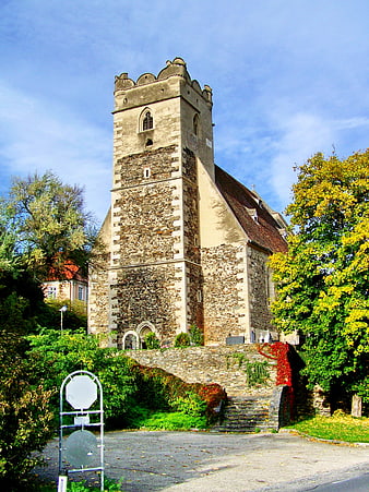Historic Gothic Church Tower in Austria with Autumn Foliage