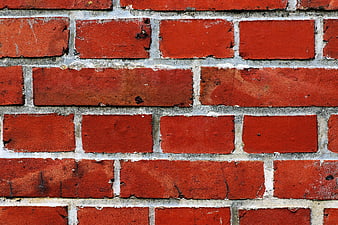 Close-up of weathered red brick wall texture
