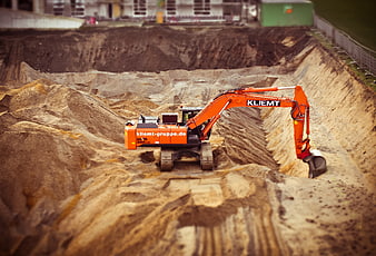 Orange Excavator Digging Earth At Construction Site