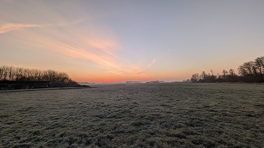 Frosty Meadow at Dawn with Soft Pink and Orange Sunrise Sky