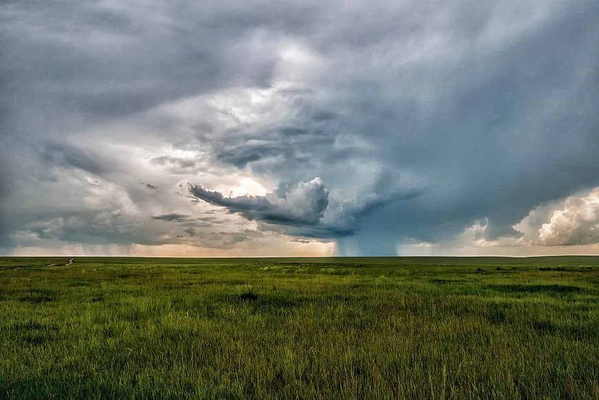 Dramatic Storm Clouds Over Green Grassland
