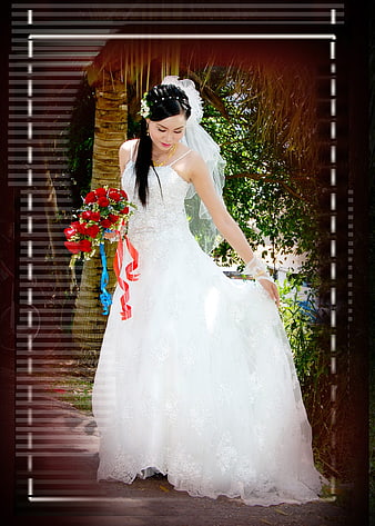 Bride in White Lace Gown Holding Red Roses