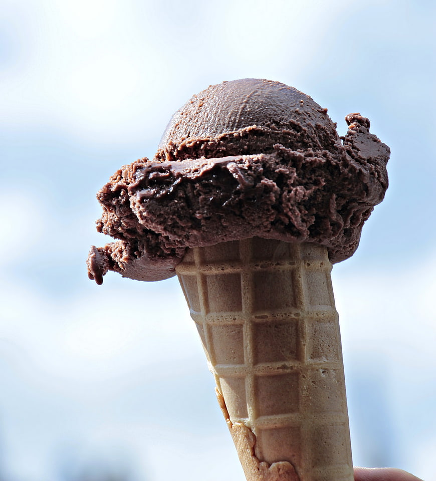 Chocolate Ice Cream Cone Against Blue Sky