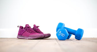 Purple Sneakers and Blue Dumbbells on Wooden Floor