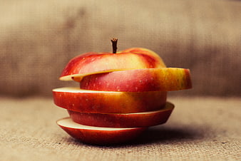 Stacked Red Apple Slices on Textured Background