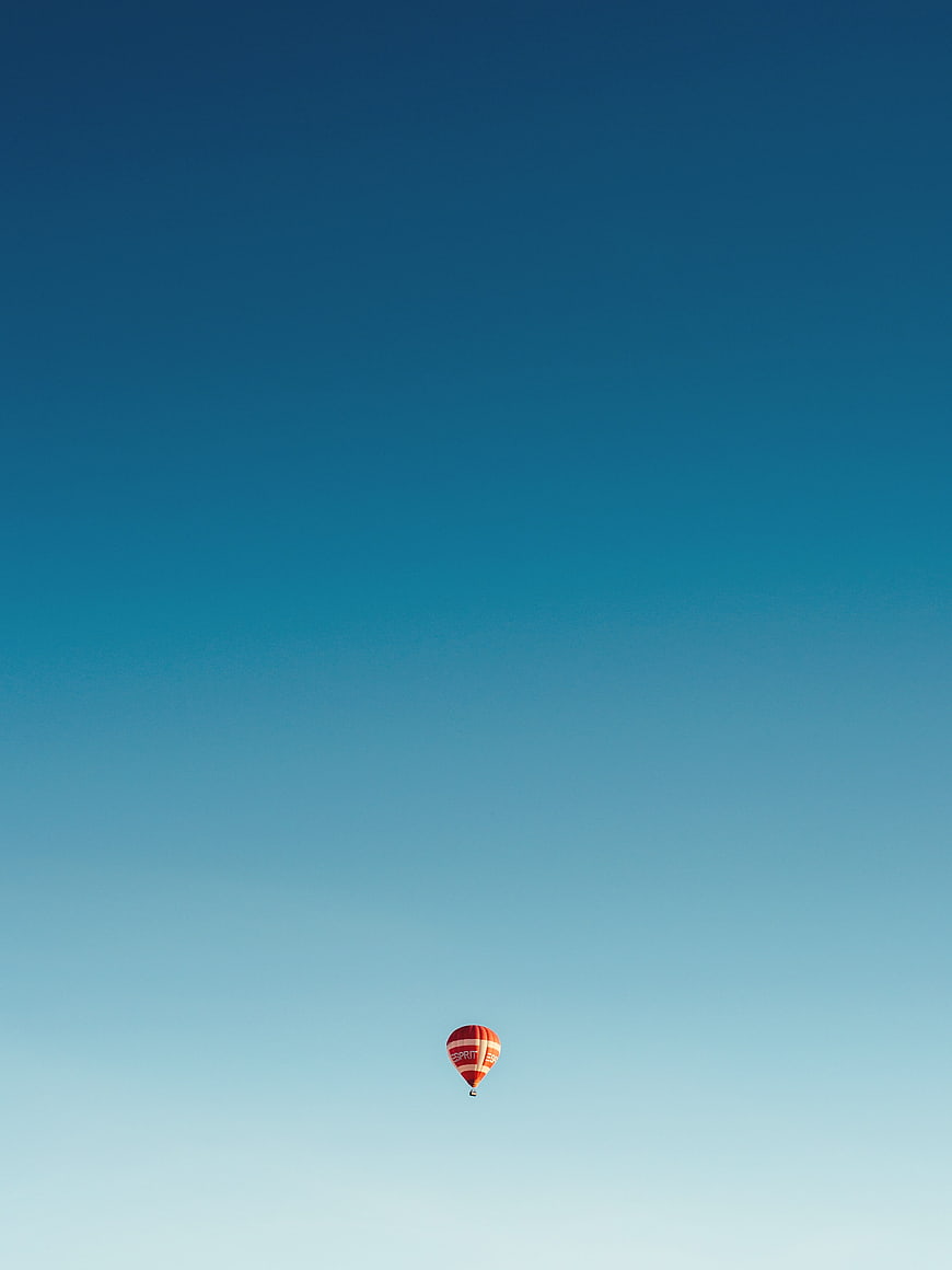 Minimalist Hot Air Balloon in Blue Gradient Sky