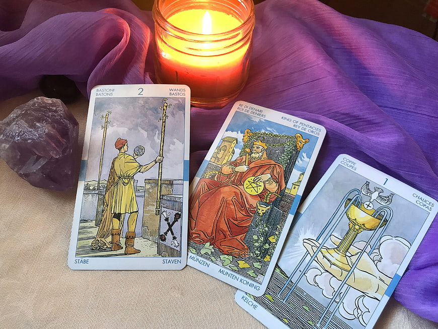 Tarot Card Reading Setup With Candle And Amethyst Crystal