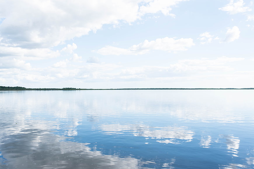 Serene Lake Reflection of Clouds and Blue Sky