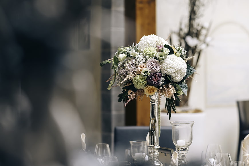 Elegant floral centerpiece on a dining table with glassware