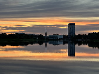 Serene Lake Reflection of City Skyline at Sunset
