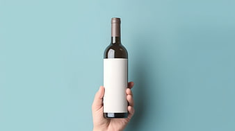 Hand holding wine bottle mockup on blue background