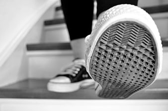 Close-up of sneaker sole on stairs in black and white