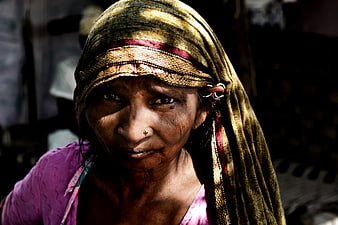 Portrait of elderly woman with traditional headscarf and nose ring