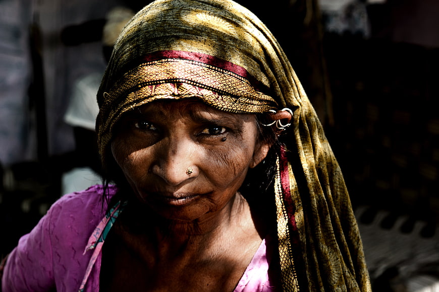 Portrait of elderly woman with traditional headscarf and nose ring