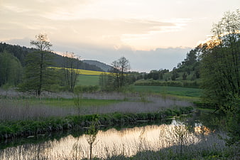 Serene River Landscape with Reflections at Sunset
