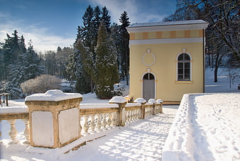 Yellow inhalatorium building in snowy winter park landscape