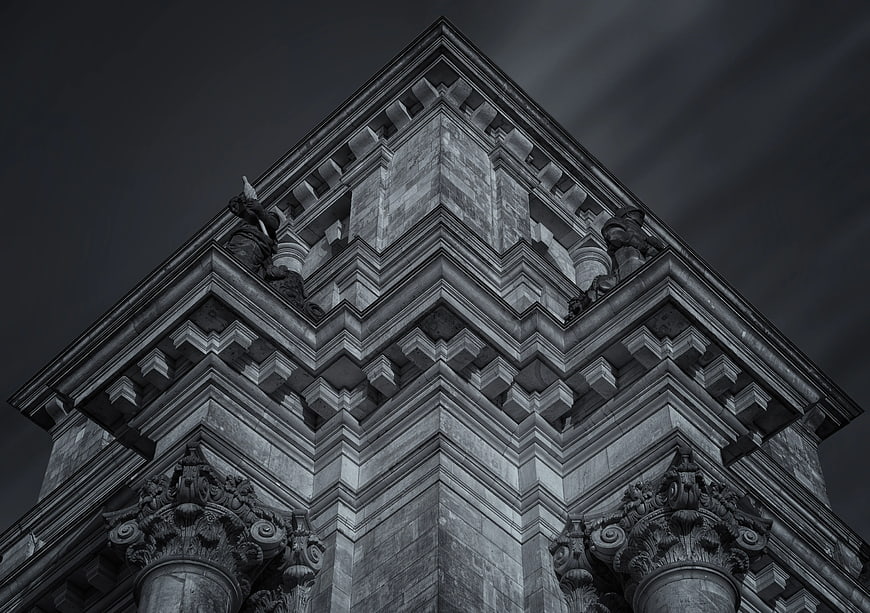 Low angle black and white architectural detail of classical building