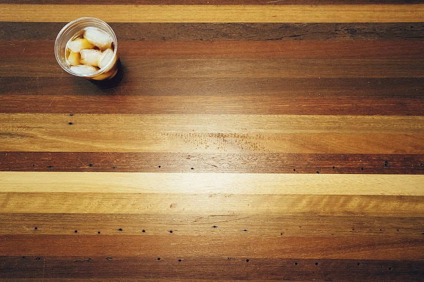 Top View of Iced Coffee on Striped Wooden Table