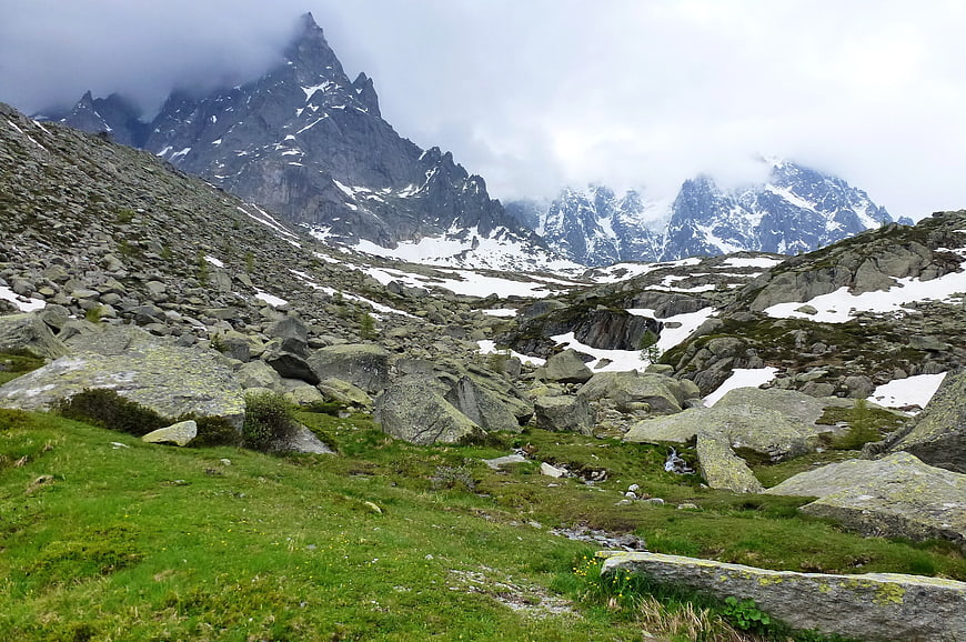 Majestic Alpine Mountain Landscape with Snow and Green Meadow