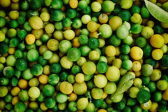 Top View of Fresh Green Limes and Yellow Lemons Pile