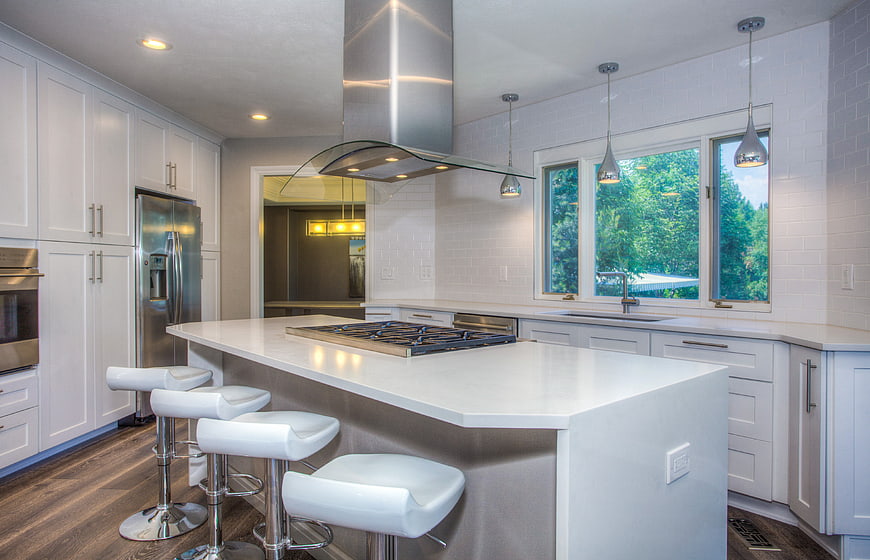 Modern white kitchen with island and stainless steel appliances