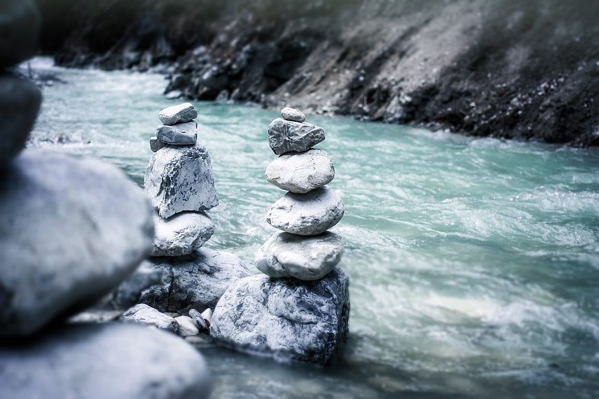 Stacked Zen Stones Balanced on River Rocks