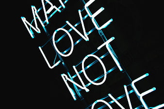 Blue Neon Sign Reading Make Love Not War on Black Background