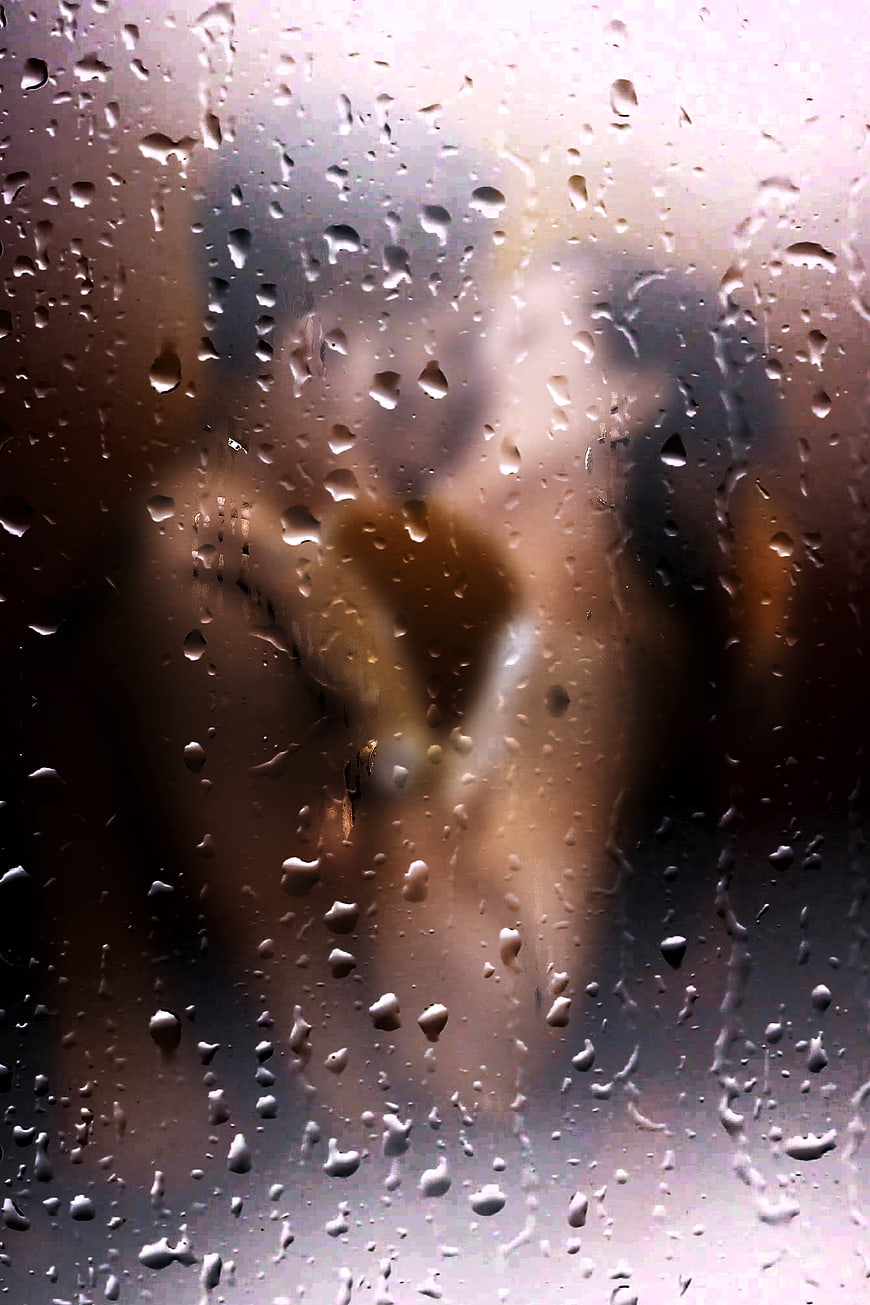 Romantic Couple Silhouette Behind Rainy Window