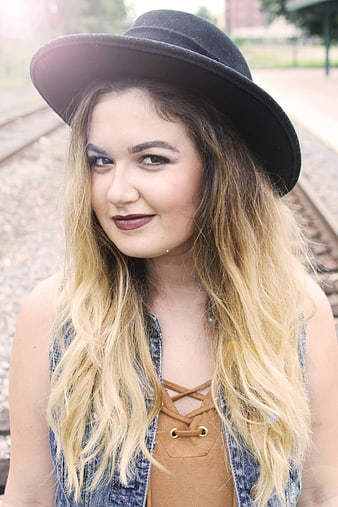 Portrait of Young Blonde Woman in Black Hat