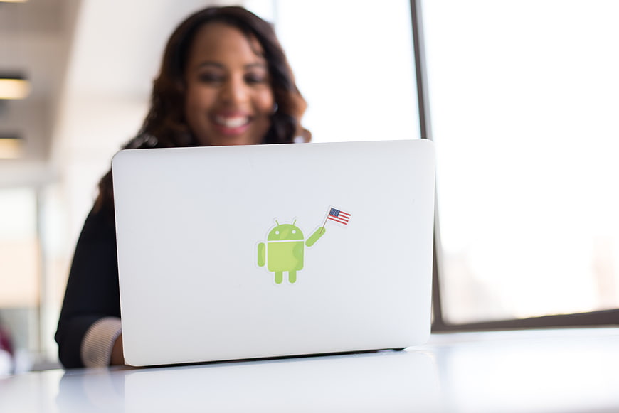 Woman with Android Sticker on Laptop in Office