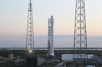 SpaceX Falcon 9 rocket on launchpad at dusk